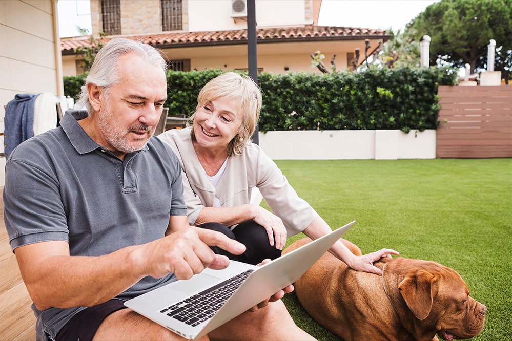 man and woman sitting outside happy they have retirement annuities
