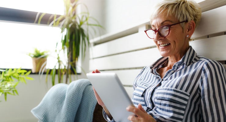 mature woman reading annuity rates